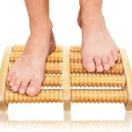 Close-up of wooden foot roller showing ergonomic design