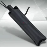Foldable umbrella-style car windshield sunshade in silver blocking sun