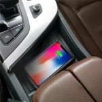 Wireless charger pad charging an iPhone in car interior