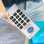 Compact white RFID NFC card reader and writer duplicator in hand