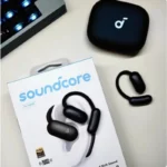Soundcore AeroFit 2 Bluetooth earphones worn by model outdoors
